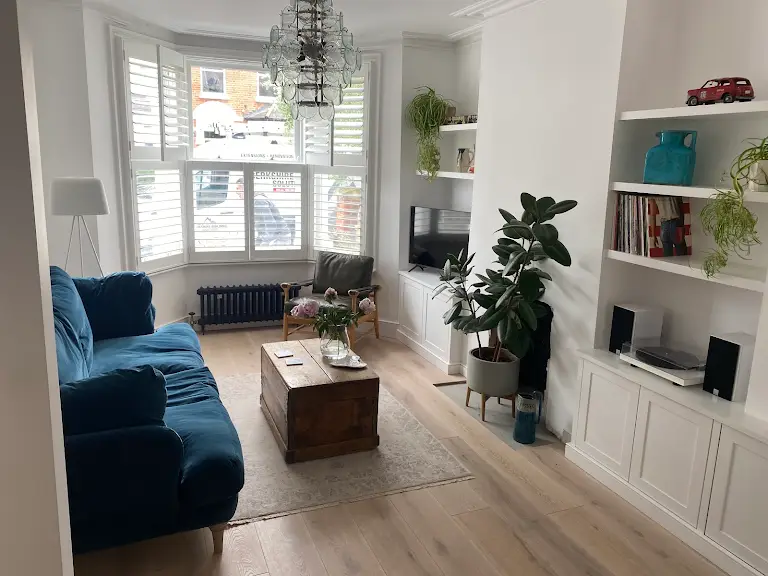 A living room filled with furniture and a large window.